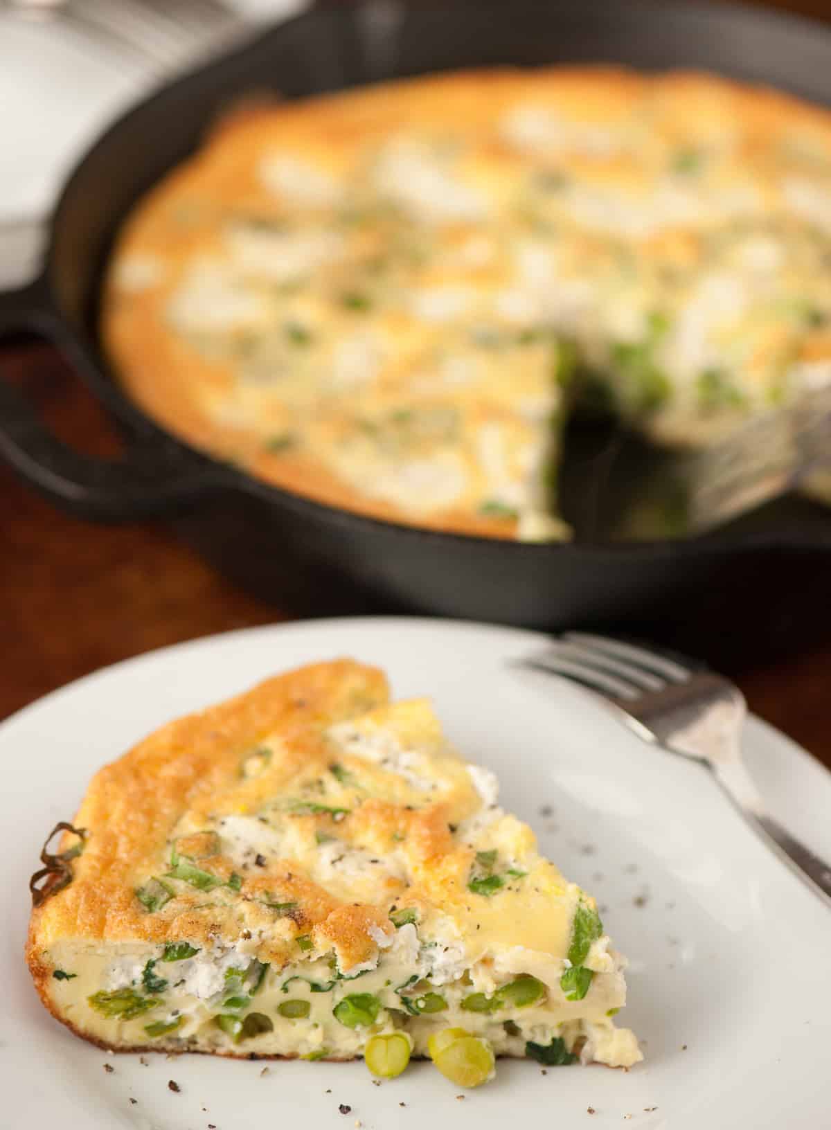 slice of spring vegetable frittata on plate.