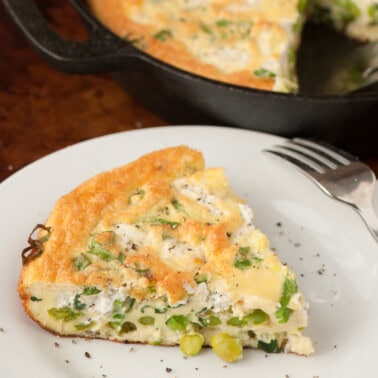 slice of spring vegetable frittata on plate.