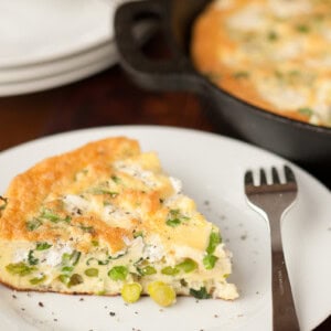 slice of spring vegetable frittata on plate.