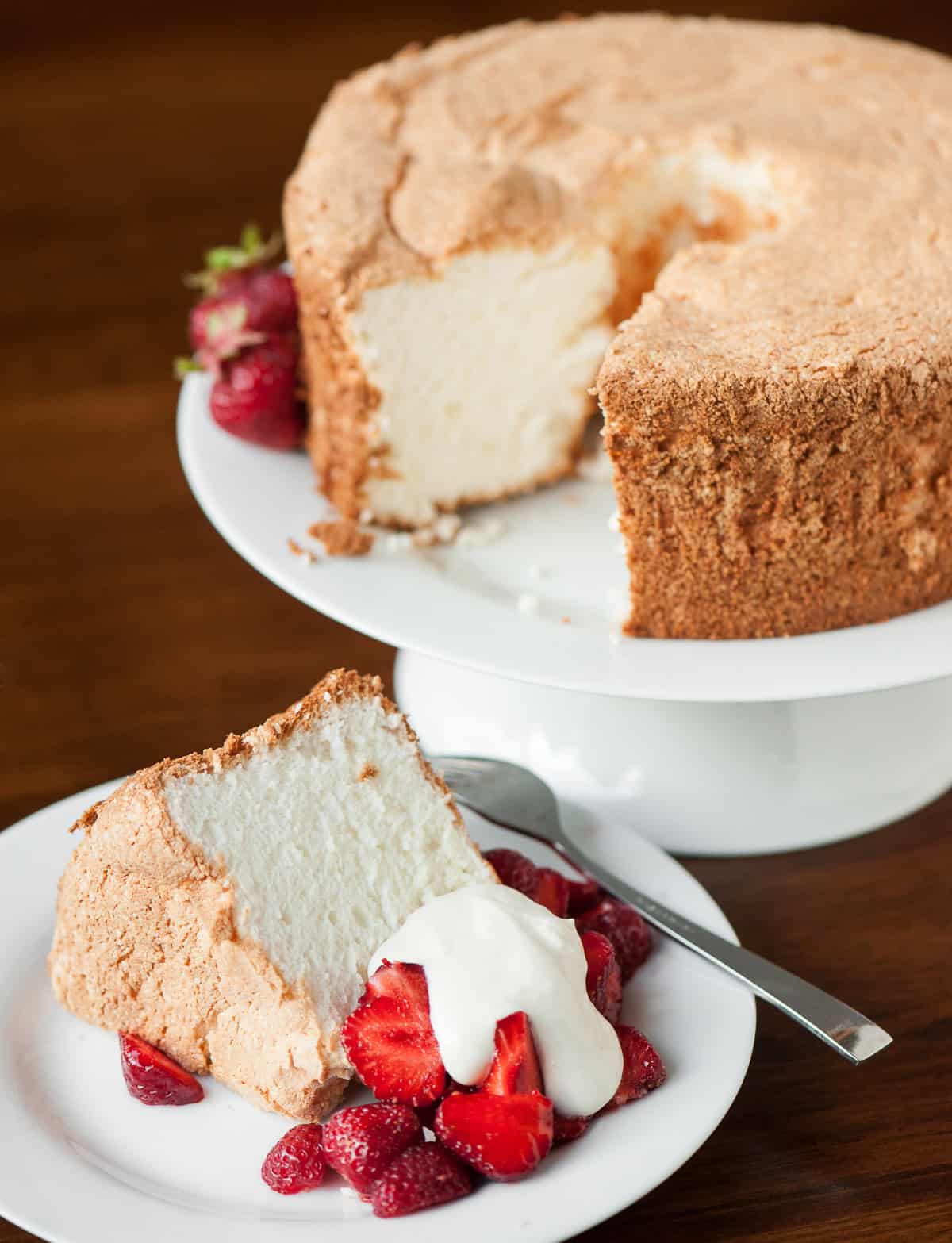 homemade angel food cake with strawberries and whipped cream.