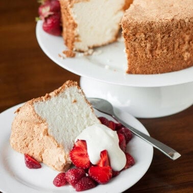 homemade angel food cake with strawberries and whipped cream.