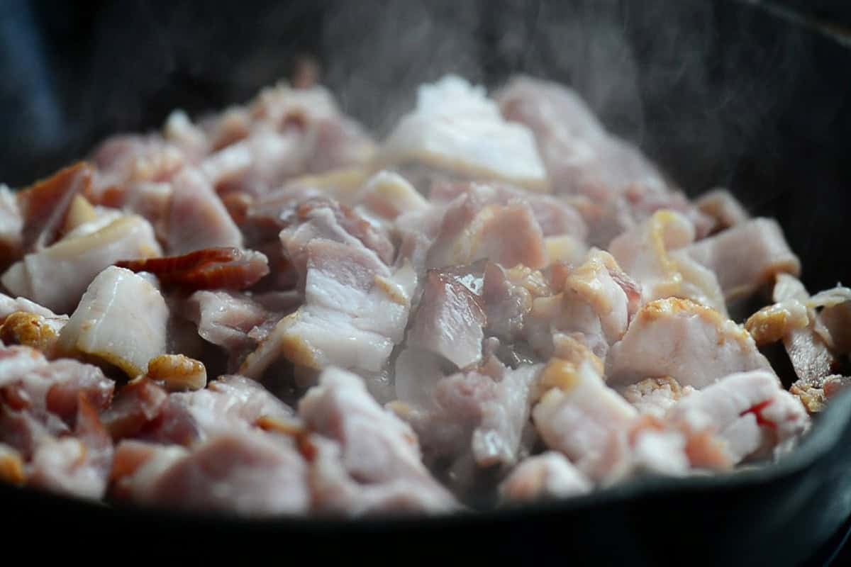 cooking bacon ends and pieces in cast iron.