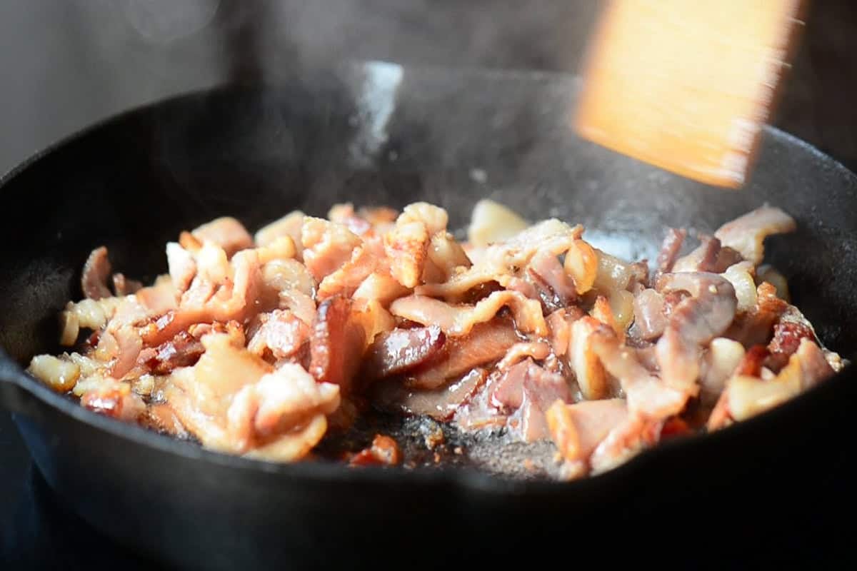 cooking bacon ends and pieces in cast iron.