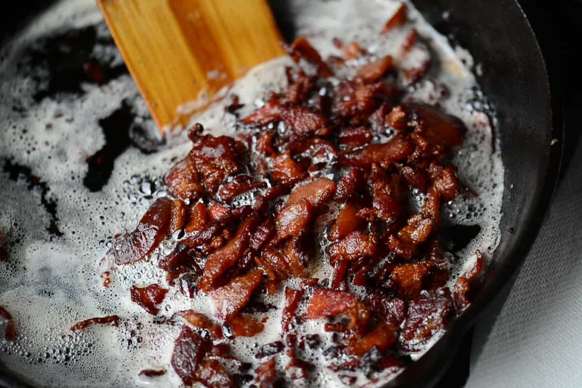 cooking bacon ends and pieces in cast iron.