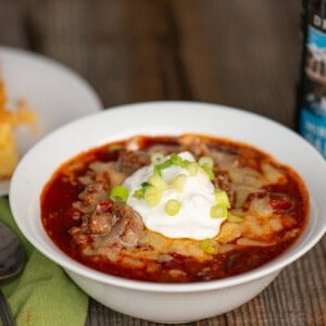 beer chili topped with cheese, sour cream, and green onions.