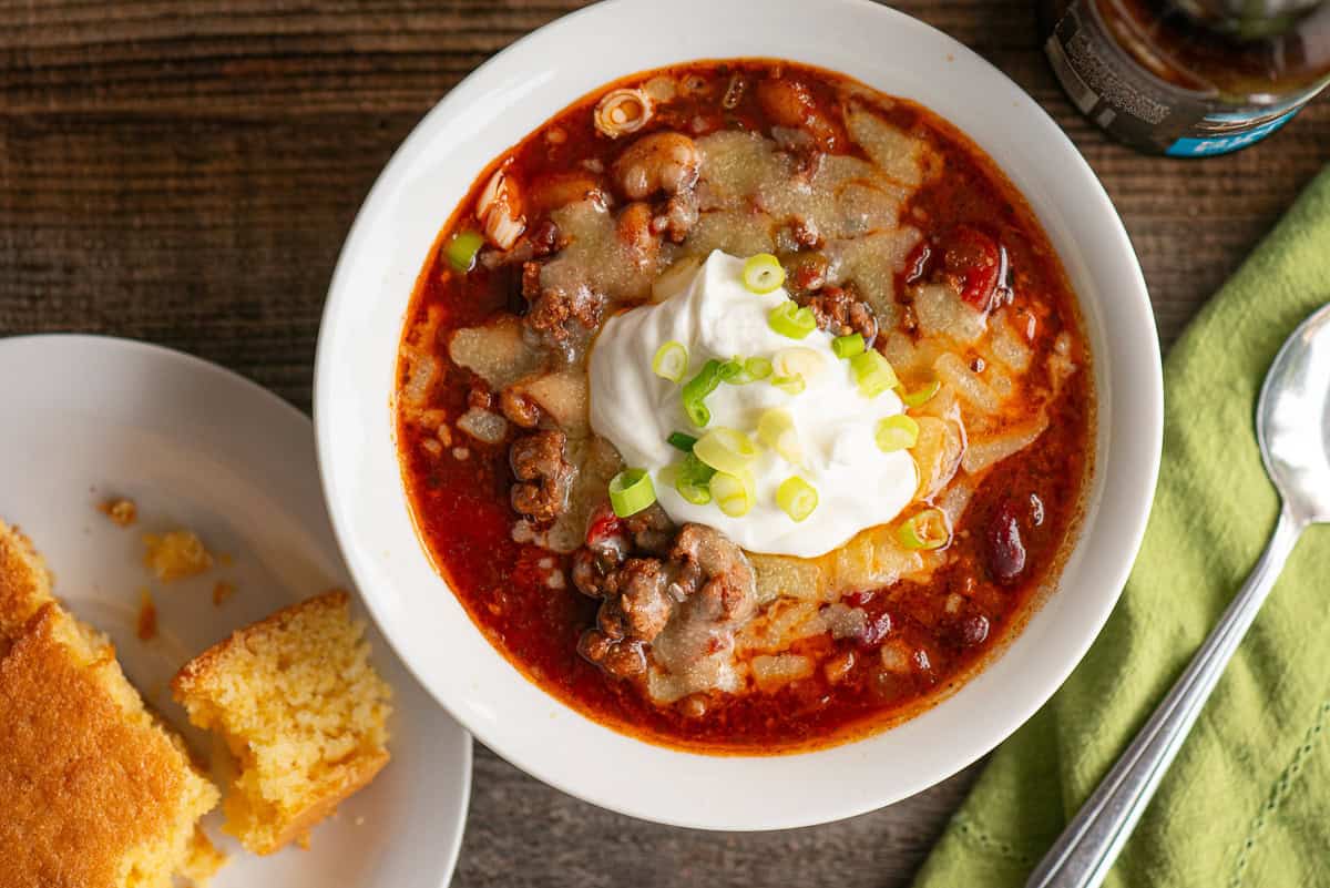 beer chili topped with cheese, sour cream, and green onions.