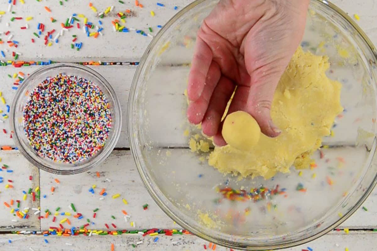 forming cookie dough into round balls.