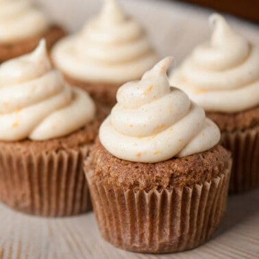 Carrot cupcakes with orange spice cream cheese frosting.