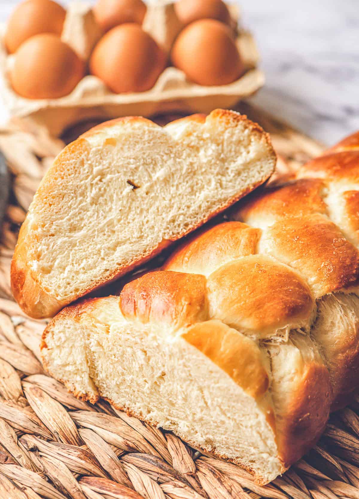 homemade challah bread with loaf cut in half.