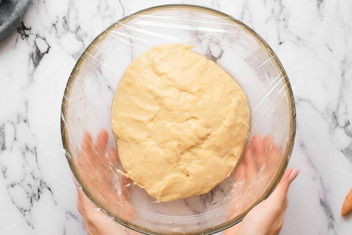 letting homemade challah bread dough rise in bowl.