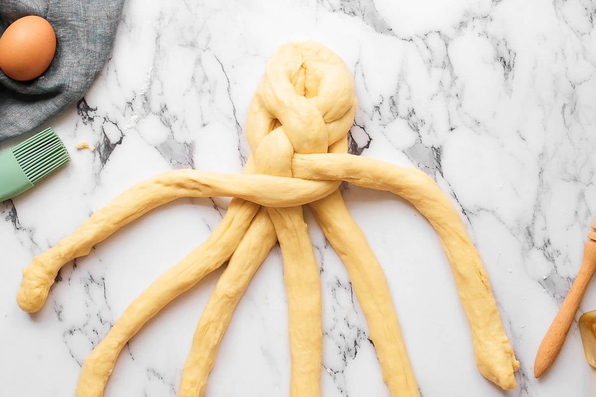 braiding homemade challah bread dough.