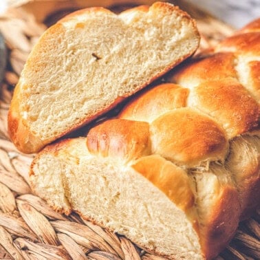 homemade challah bread loaf cut in half.