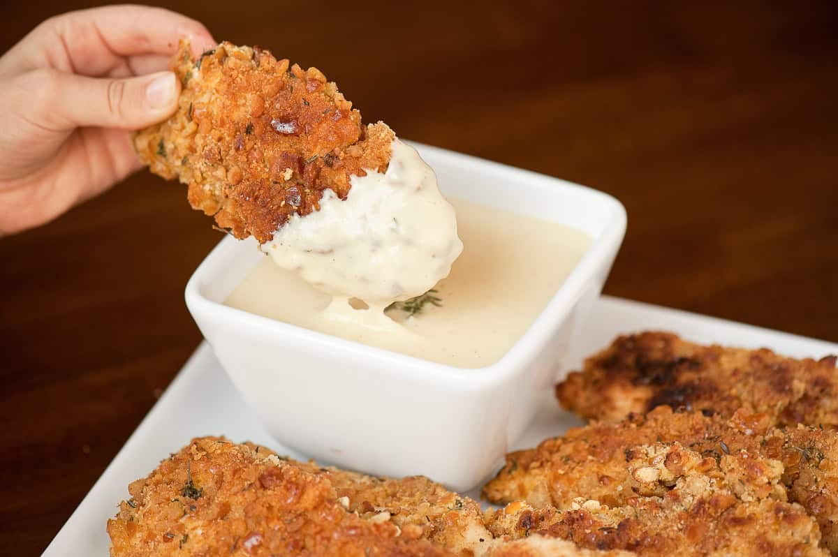 pretzel coated chicken tenders with warm cheddar cheese sauce.