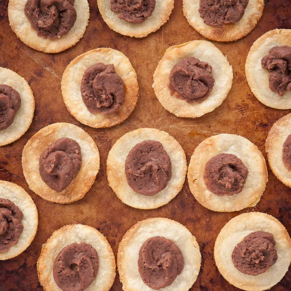 refried beans on tortillas for tostadas.