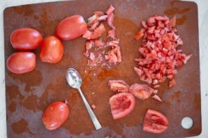 removing seeds and pulp from roma tomatoes.