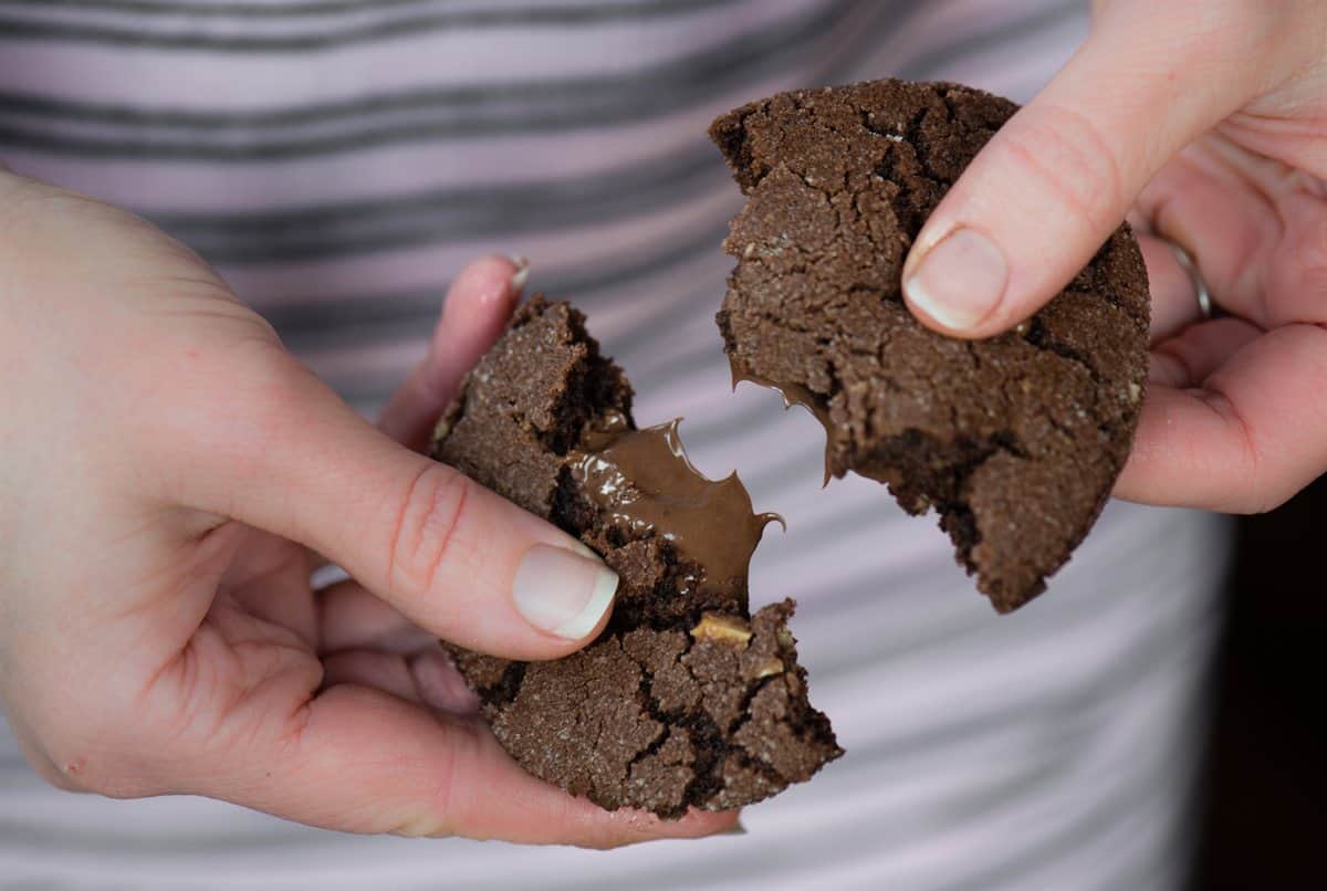 Half of a Nutella stuffed chocolate cookie showing the creamy Nutella filling