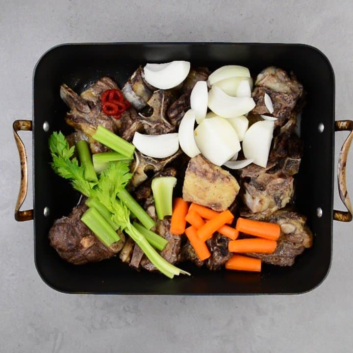 onions, celery and carrots added to the roasted beef bones.