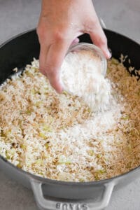 adding flour to browned rice