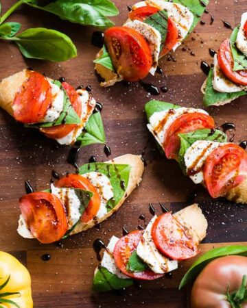Caprese bruschetta with tomatoes on the side