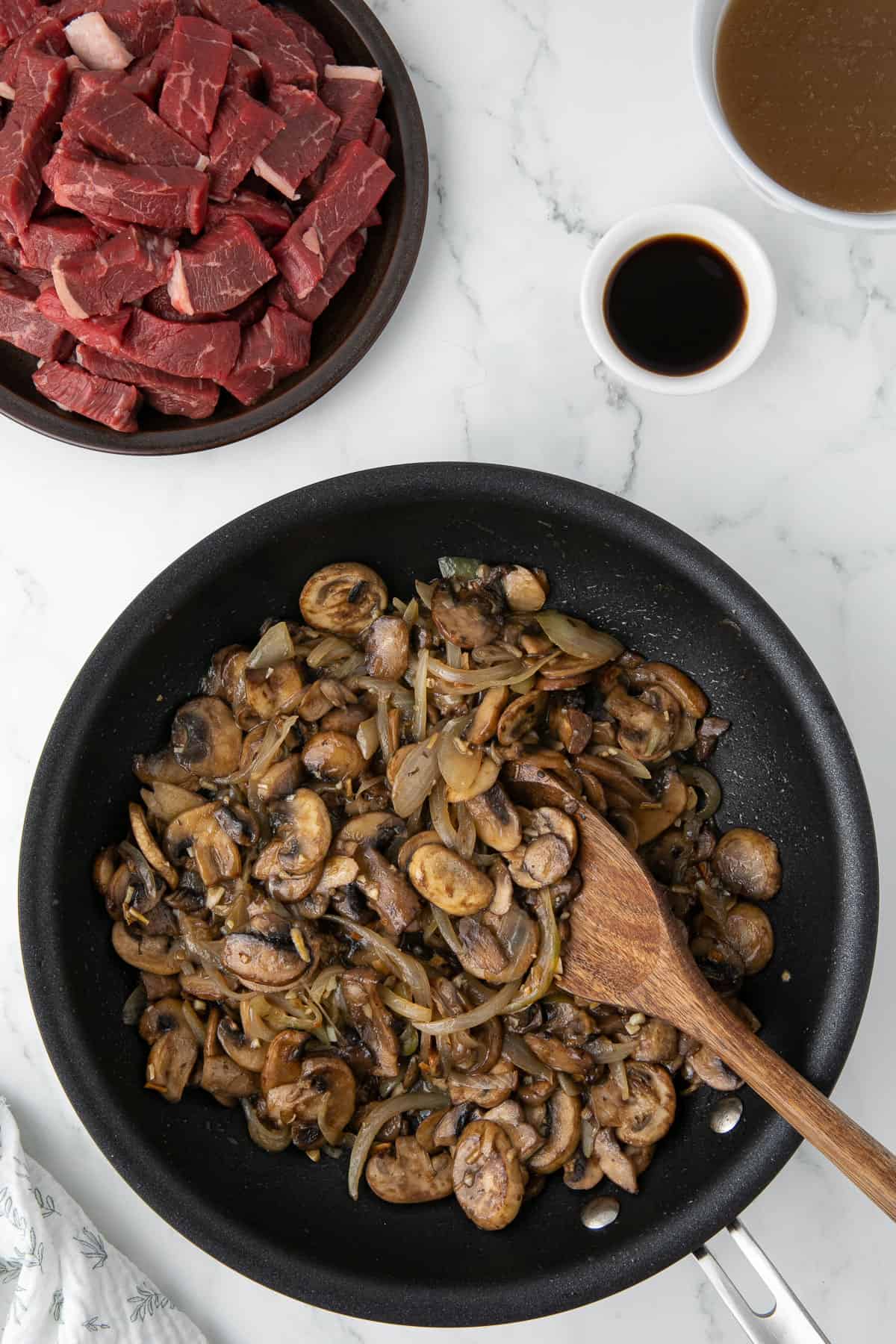 sauteed mushrooms and onions in pan.