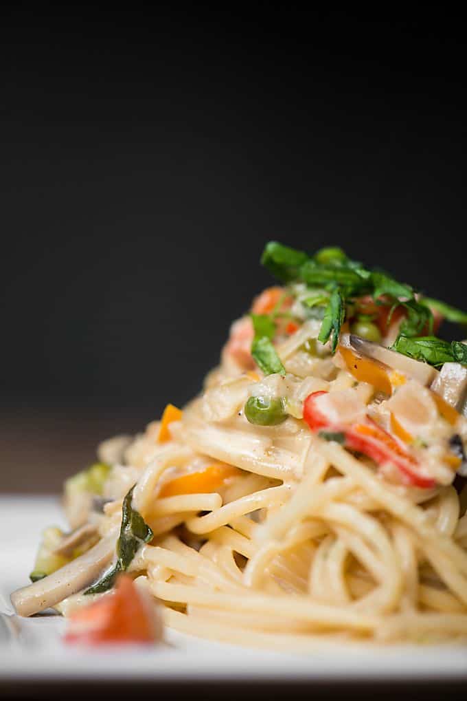 A close up of a plate of food with veggie pasta primavera