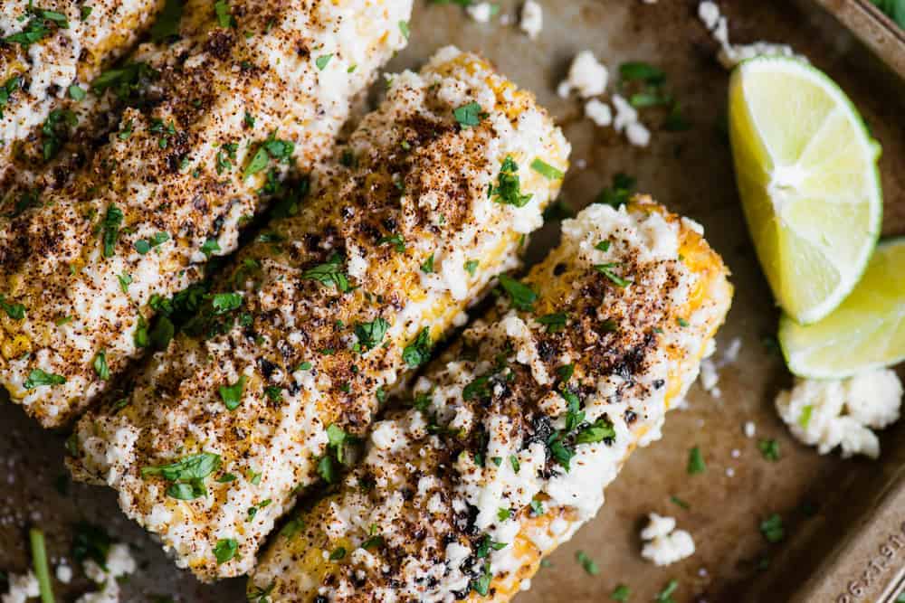 Elote Mexican Street Corn covered with sauce and cheese