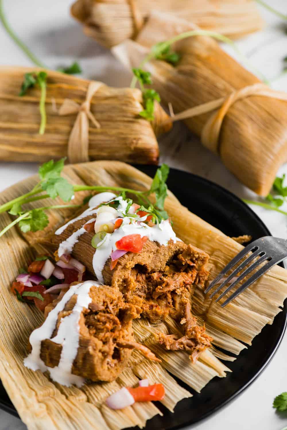 homemade authentic pork tamales wrapped in corn husks