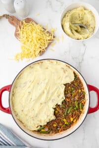 adding mashed potatoes for shepherd's pie