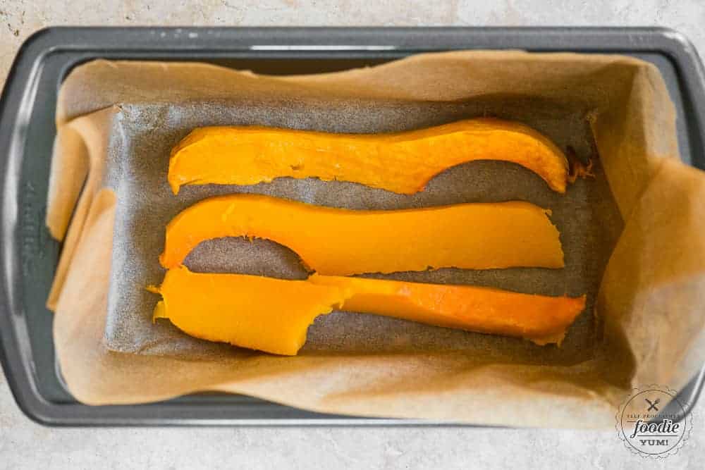 sliced roasted butternut squash in bread pan.