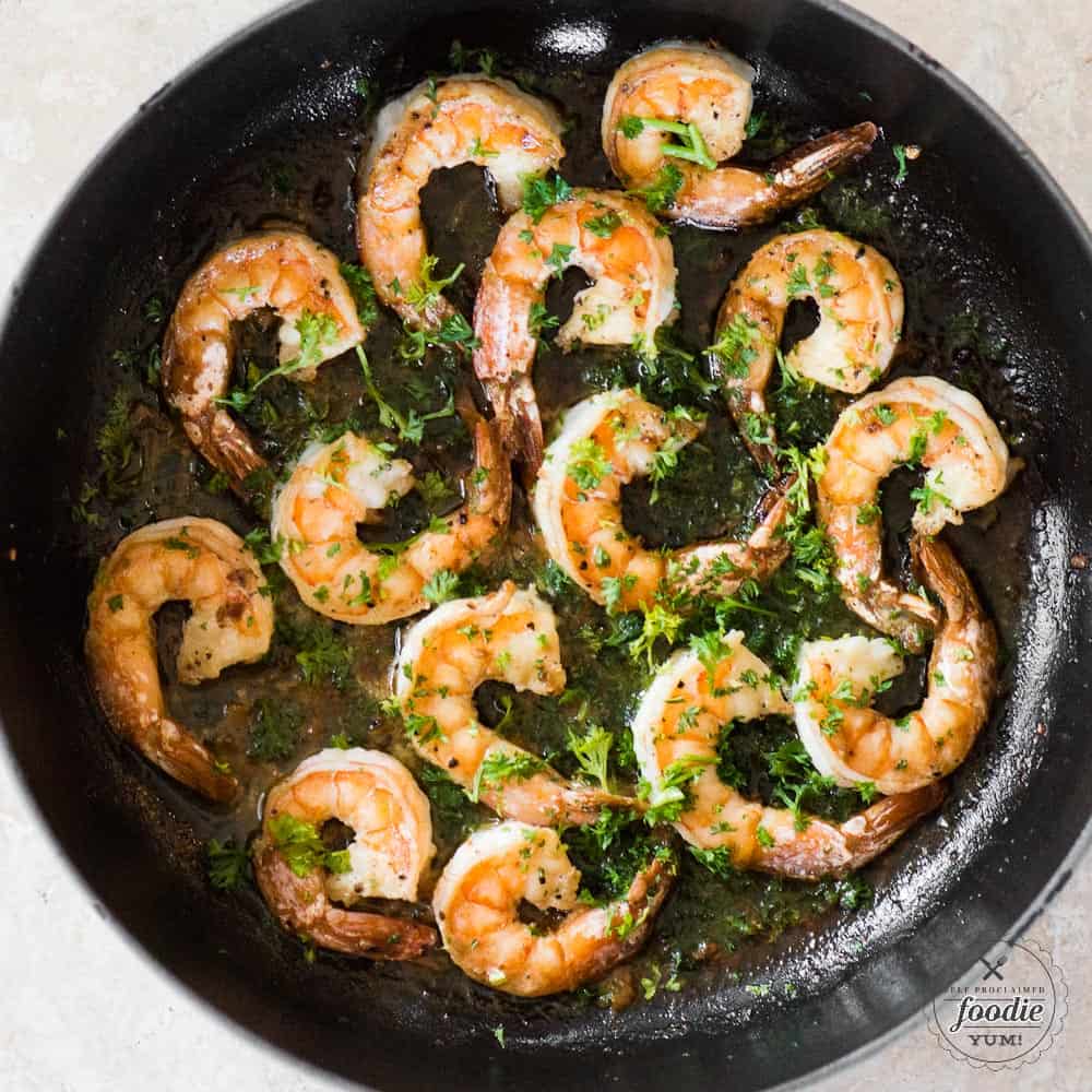 tail on shrimp in pan with parsley