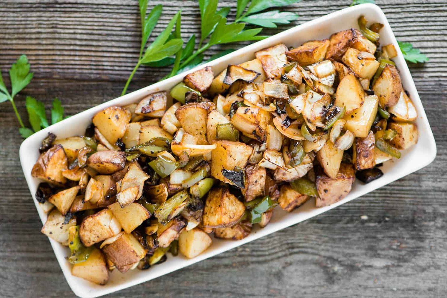 A plate of breakfast potatoes on a table