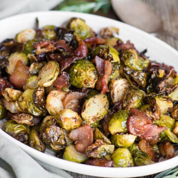 air fryer brussels sprouts and bacon on white oval dish
