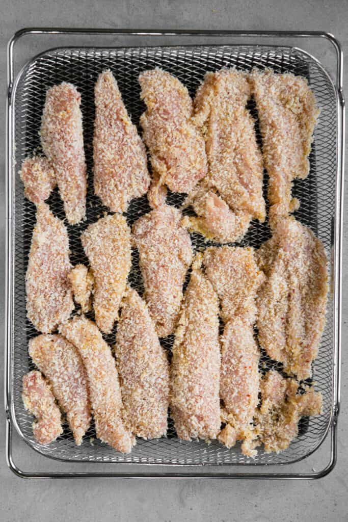 coated chicken tenders in air fryer basket