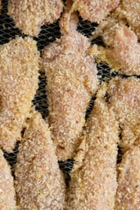 raw chicken tenders sprayed with olive oil