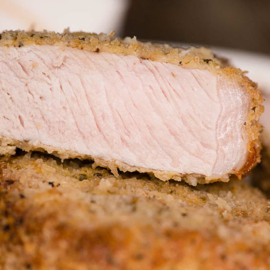 close up of a a cut breaded pork chop