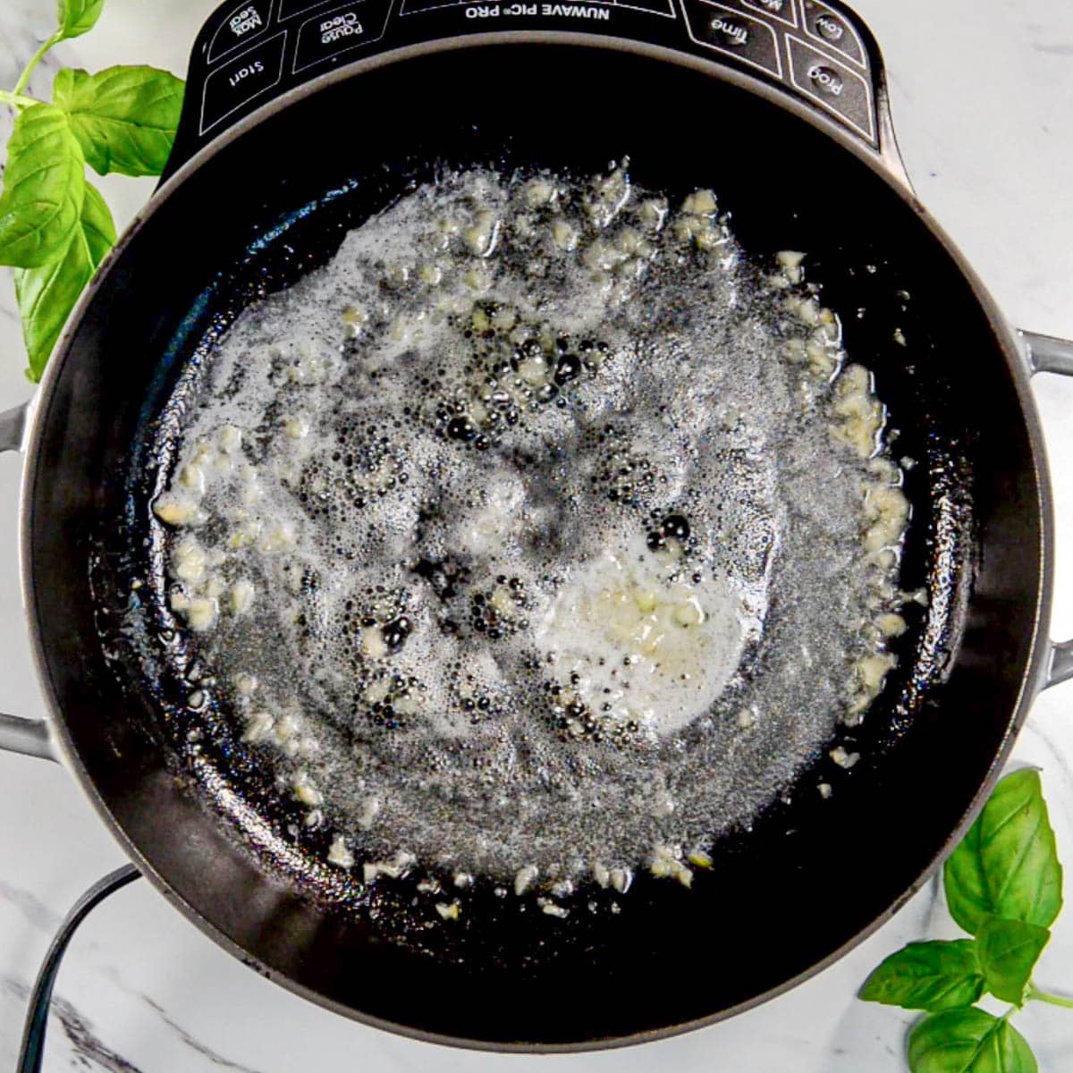 slowly cooking butter and garlic in saucepan.