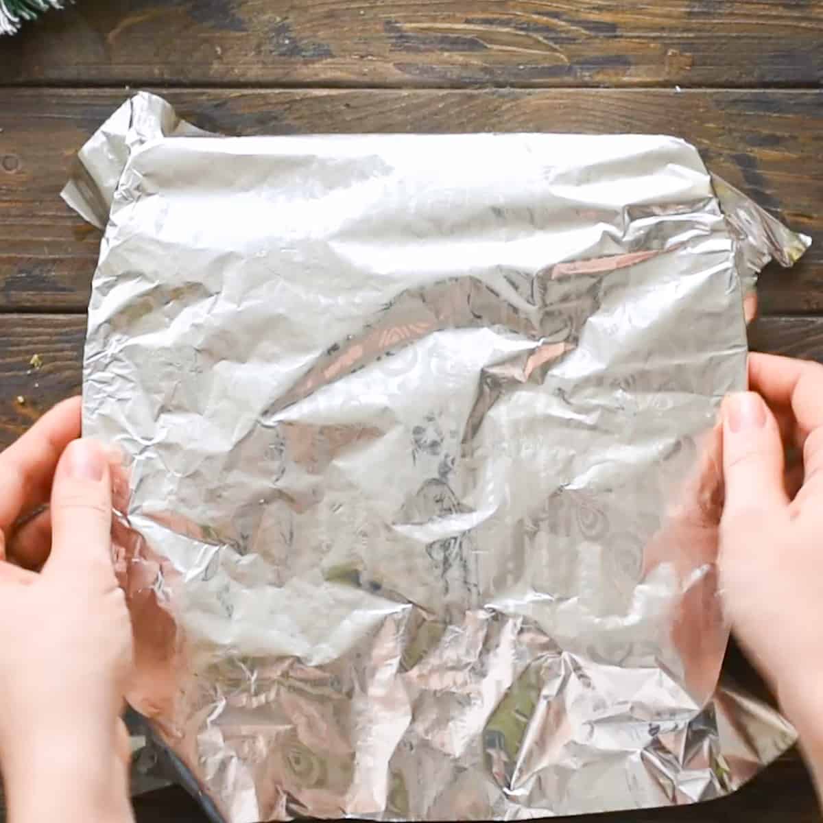 Covering a 9x9 inch baking dish with foil.