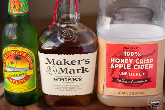 A bottle of ginger beer, whiskey, and apple cider