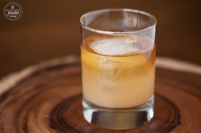 A glass of apple cider with bourbon whiskey