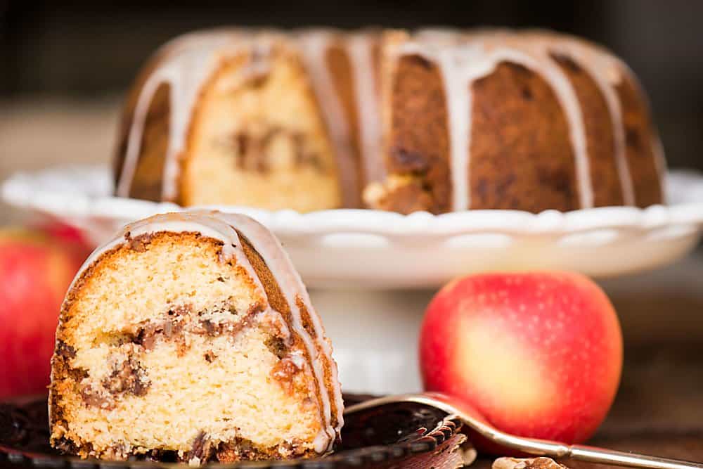 a slice of apple pecan bundt cake