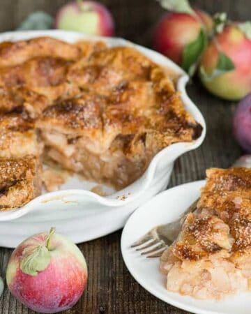 whole pie with slice made of fresh apples and homemade crusts
