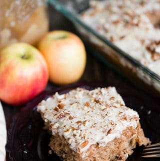 slice of scratch made applesauce cake with brown butter frosting on plate