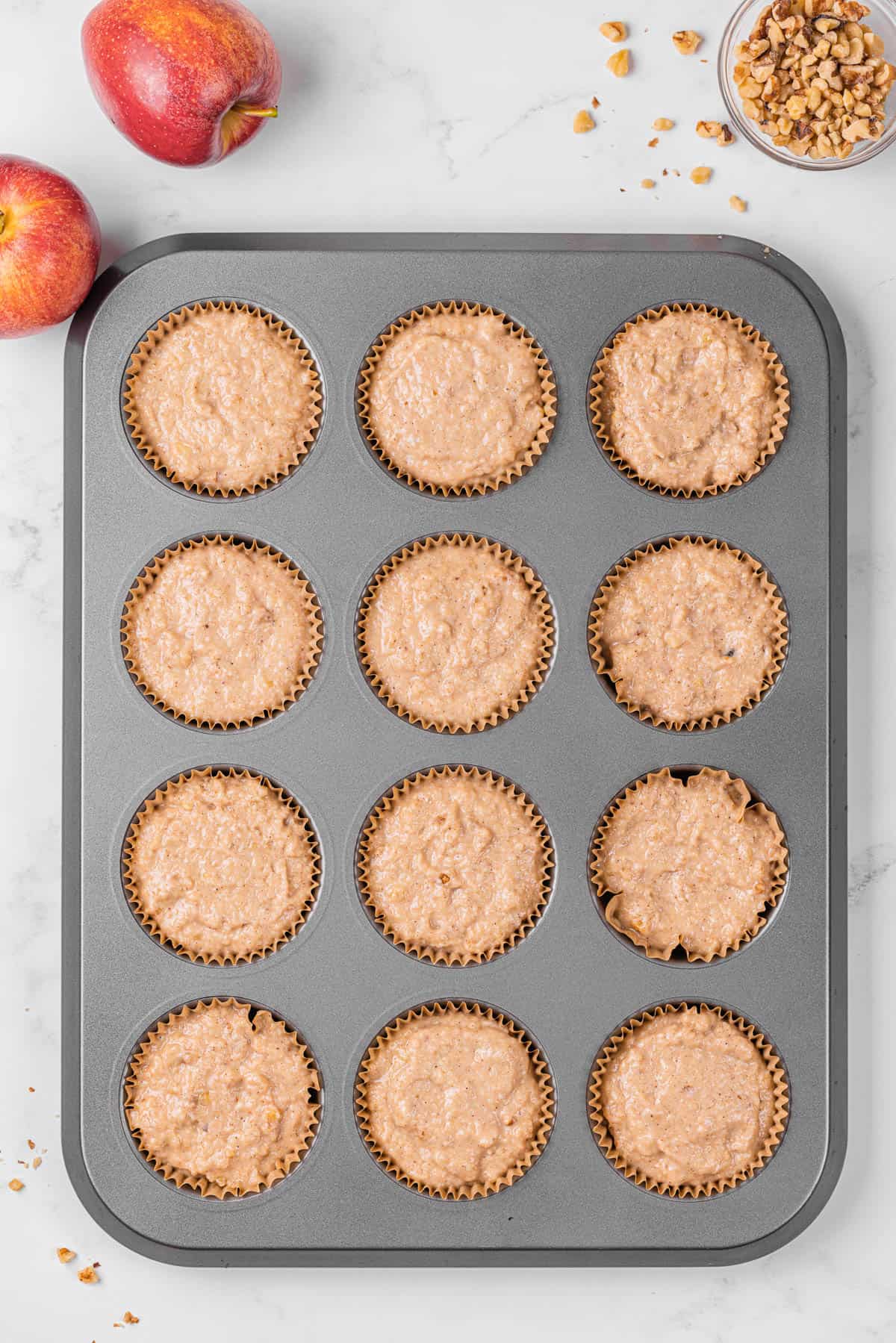 applesauce muffin batter in lined muffin tin.