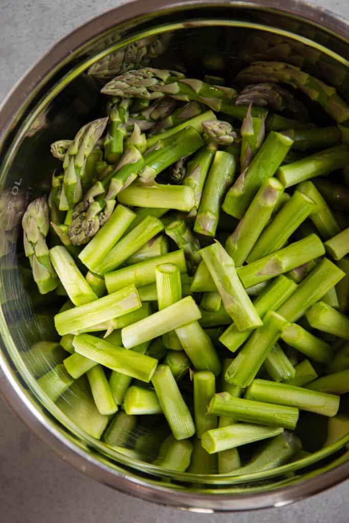 cut and peeled asparagus in bowl