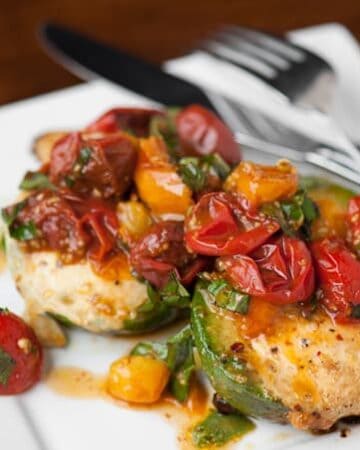 Looking for a rich and delicious breakfast that is also healthy and gluten free? These Avocado Eggs with Warm Basil Tomatoes are a must-make recipe.