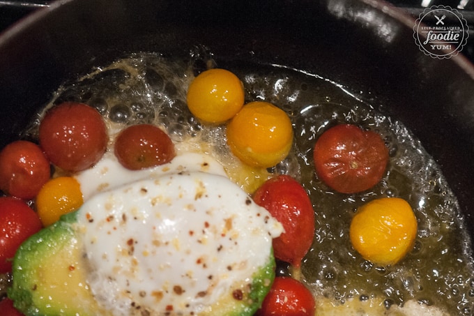 cherry tomatoes cooking in pan with egg