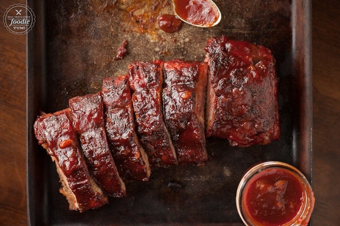 looking down at sliced pork ribs with bbq sauce