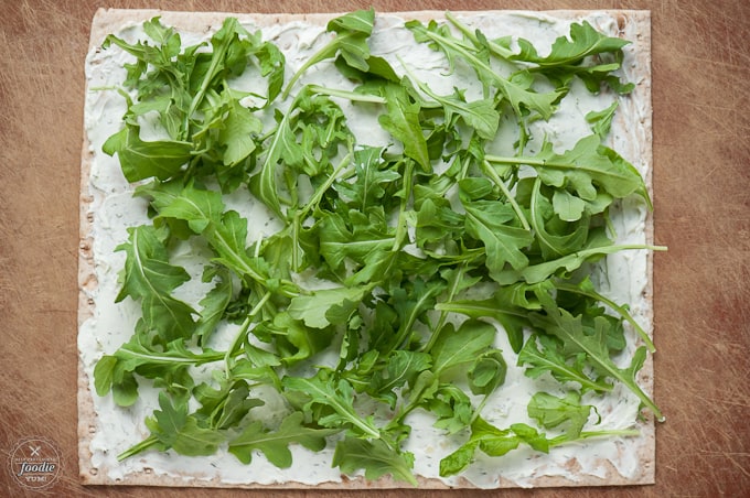 arugula on cream cheese tortilla