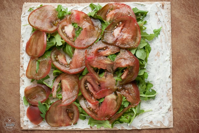 tomato, arugula, cream cheese on tortilla for roll up