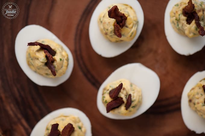 top down look at homemade deviled eggs with bacon and fresh jalapeno